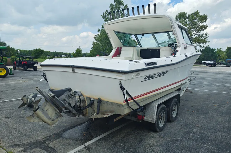 Slide: The Image of 1996 SportsCraft 232HT boat on trailer in parking lot, rear view. - 8