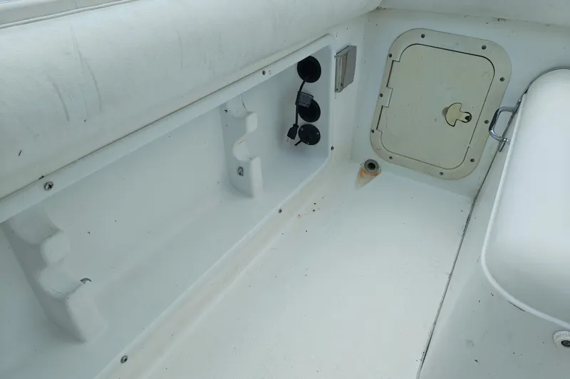 Slide: The Image of Interior of a 1996 SportsCraft 232HT boat, featuring storage compartments and seating area. - 15