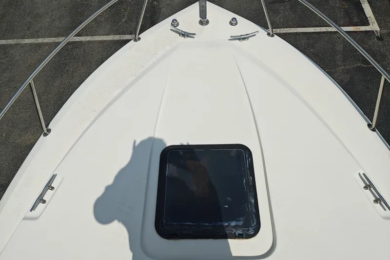 Slide: The Image of Bow of a 1996 SportsCraft 232HT boat with a hatch and railing. - 37