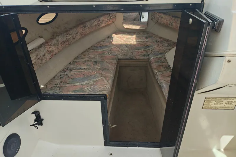 Slide: The Image of Interior cabin of a 1996 SportsCraft 232HT boat with patterned seating. - 27