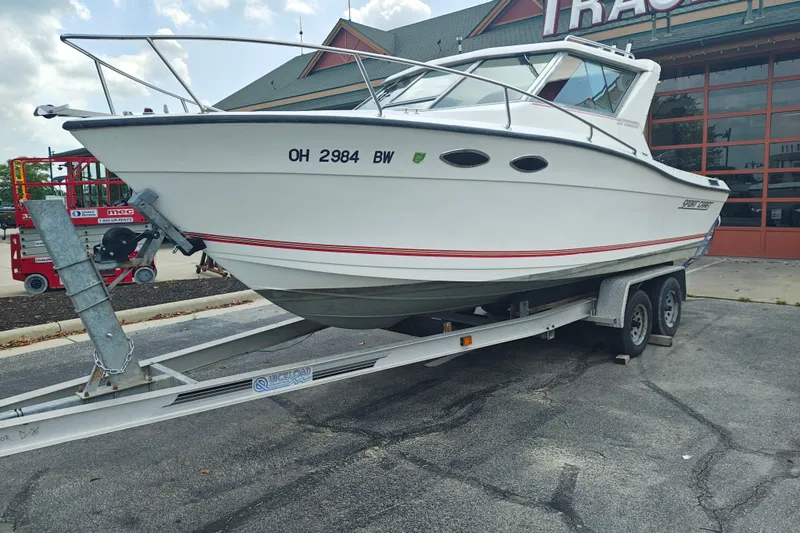 Slide: The Image of 1996 SportsCraft 232HT boat on trailer, parked outside a building. - 5