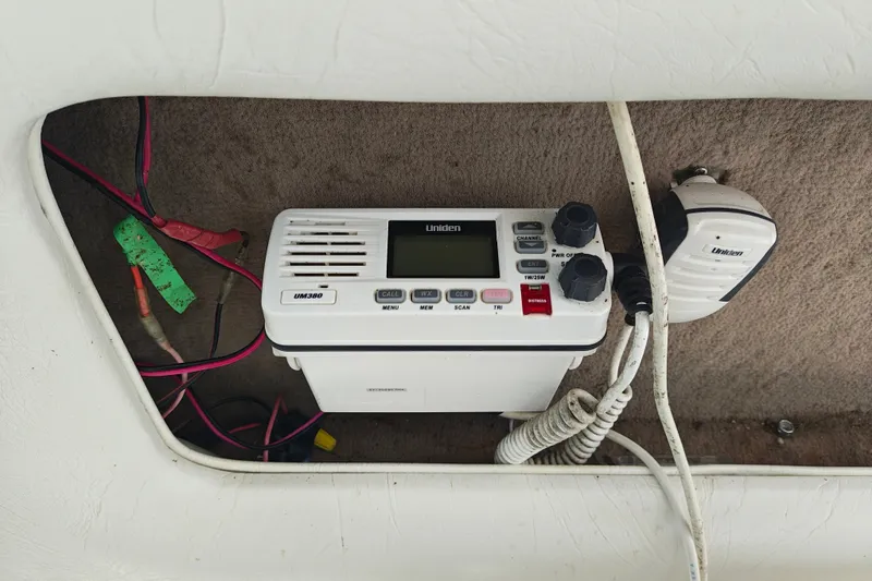 Slide: The Image of Marine radio equipment in a 1996 SportsCraft 232HT boat, featuring Uniden UM380 model. - 25