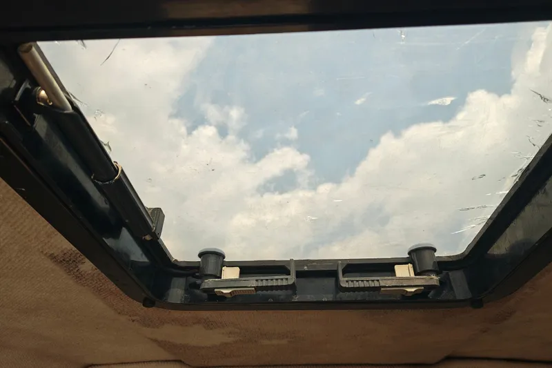 Slide: The Image of Sunroof view from a 1996 SportsCraft 232HT, showcasing a partly cloudy sky. - 32
