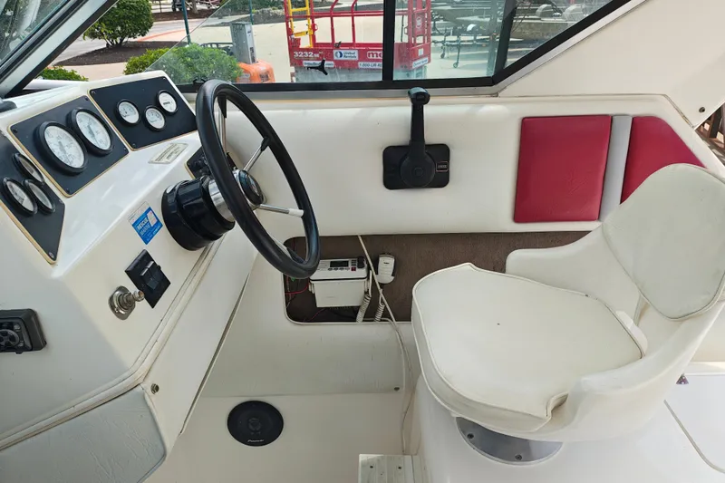 Slide: The Image of Interior of a 1996 SportsCraft 232HT boat showing steering wheel and control panel. - 24