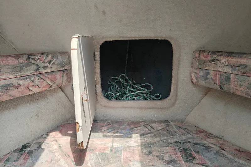Slide: The Image of Interior of a 1996 SportsCraft 232HT boat with open storage compartment. - 31
