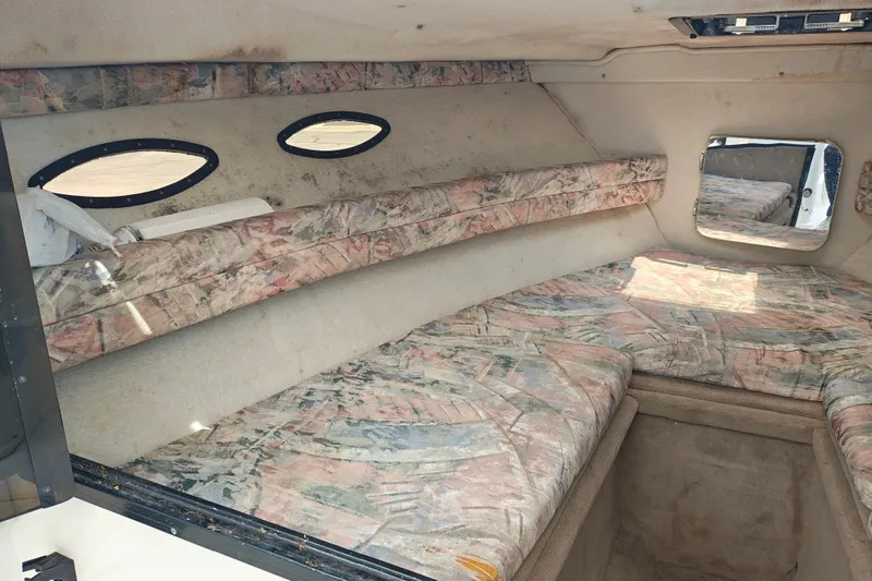 Slide: The Image of Interior cabin of a 1996 SportsCraft 232HT boat with patterned upholstery. - 28