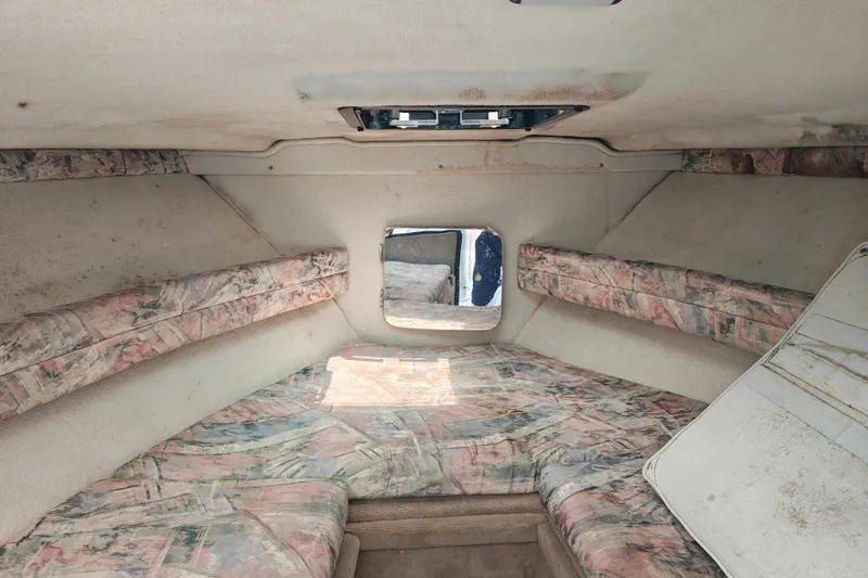 Slide: The Image of Interior cabin of a 1996 SportsCraft 232HT boat with patterned upholstery. - 29