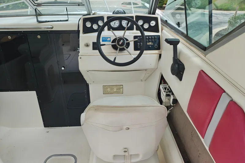 Slide: The Image of Interior of a 1996 SportsCraft 232HT boat showing steering wheel and dashboard controls. - 20