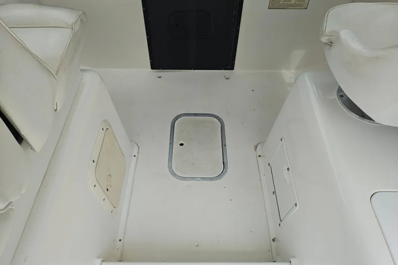Slide: The Image of Interior of a 1996 SportsCraft 232HT boat, featuring seating and storage compartments. - 21