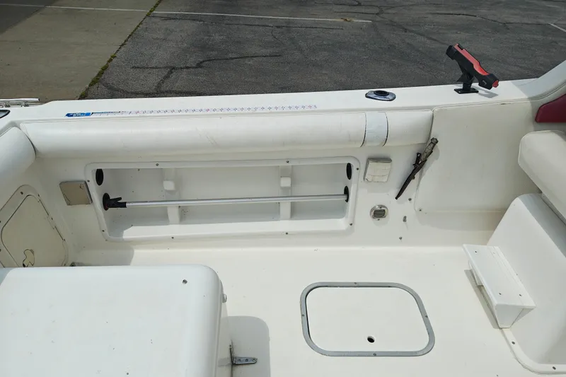 Slide: The Image of Interior of a 1996 SportsCraft 232HT boat showing storage compartments and seating area. - 12