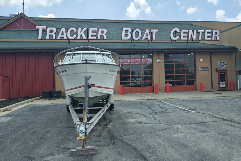 Slide: The Image of White SportsCraft 232HT boat on trailer outside Tracker Boat Center, 1996 model. - 3