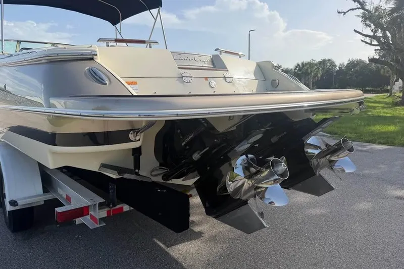 Slide: The Image of 2018 Chris-Craft Corsair 30 boat rear view with dual propellers on a trailer. - 19
