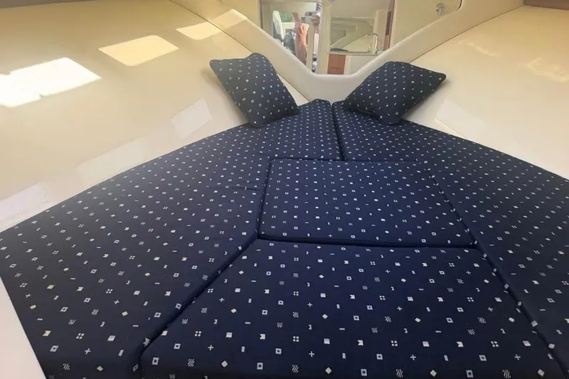 Slide: The Image of 2018 Chris-Craft Corsair 30 cabin interior with patterned blue cushions and pillows. - 13