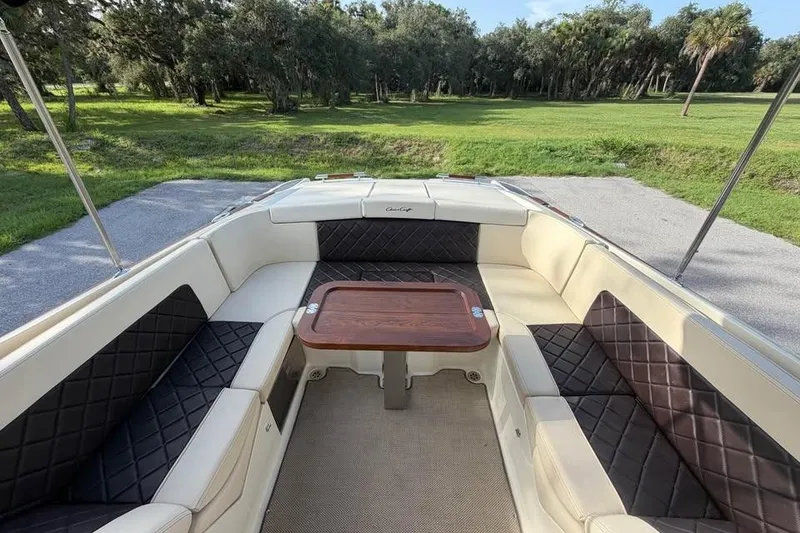 Slide: The Image of Luxurious 2018 Chris-Craft Corsair 30 boat interior with elegant seating and wooden table. - 17