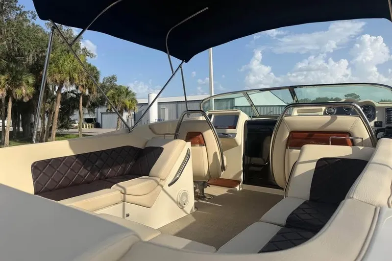 Slide: The Image of 2018 Chris-Craft Corsair 30 boat interior with luxurious seating and canopy. - 16