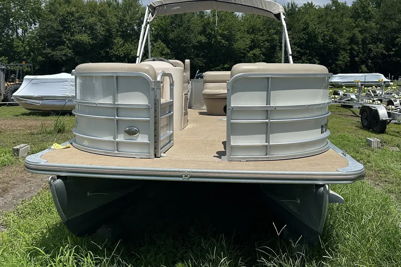 Slide: The Image of 2018 Berkshire 22RFC CTS pontoon boat on grassy area, surrounded by trees. - 2