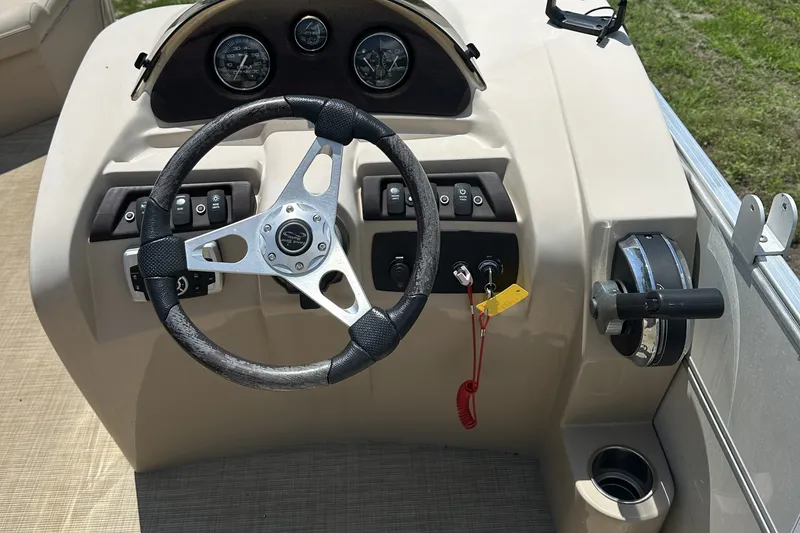 Slide: The Image of Steering console of a 2018 Berkshire 22RFC CTS pontoon boat with gauges and controls. - 8