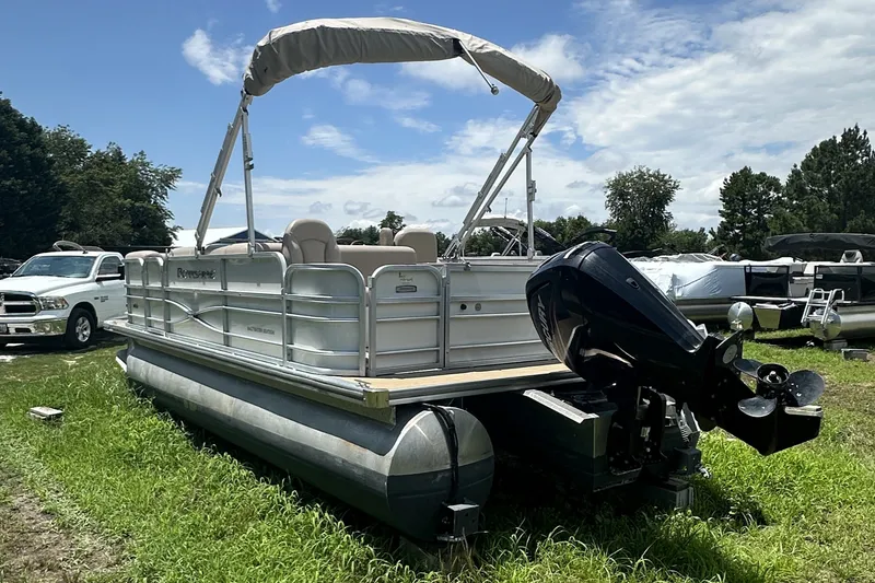 Slide: The Image of 2018 Berkshire 22RFC CTS pontoon boat with canopy and outboard motor on grassy area. - 4