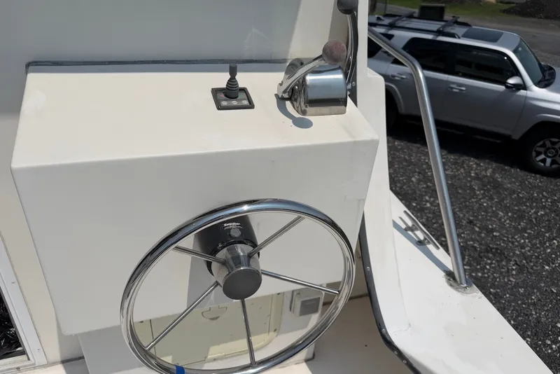 Slide: The Image of Helm of 1999 Judge Eastern 31 Flybridge boat with steering wheel and throttle controls. - 6