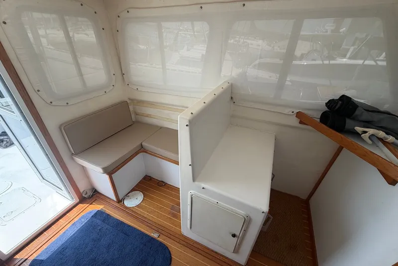 Slide: The Image of Interior of 1999 Judge Eastern 31 Flybridge with seating and wooden flooring. - 8