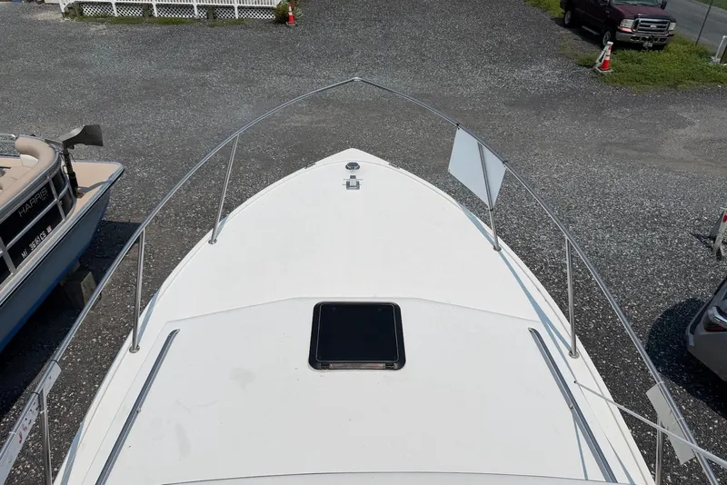 Slide: The Image of 1999 Judge Eastern 31 Flybridge boat deck view in a parking area. - 16