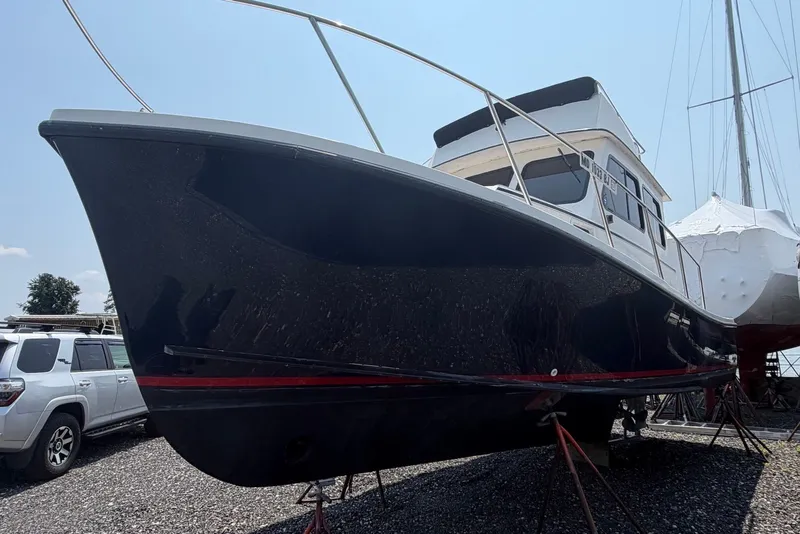 Slide: The Image of 1999 Judge Eastern 31 Flybridge boat on dry dock, side view. - 4