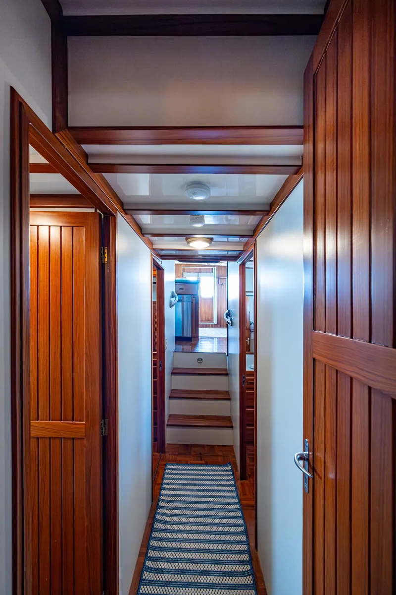 Slide: The Image of Hallway of 2000 Kadey-Krogen 48 North Sea yacht with wooden doors and striped rug. - 42