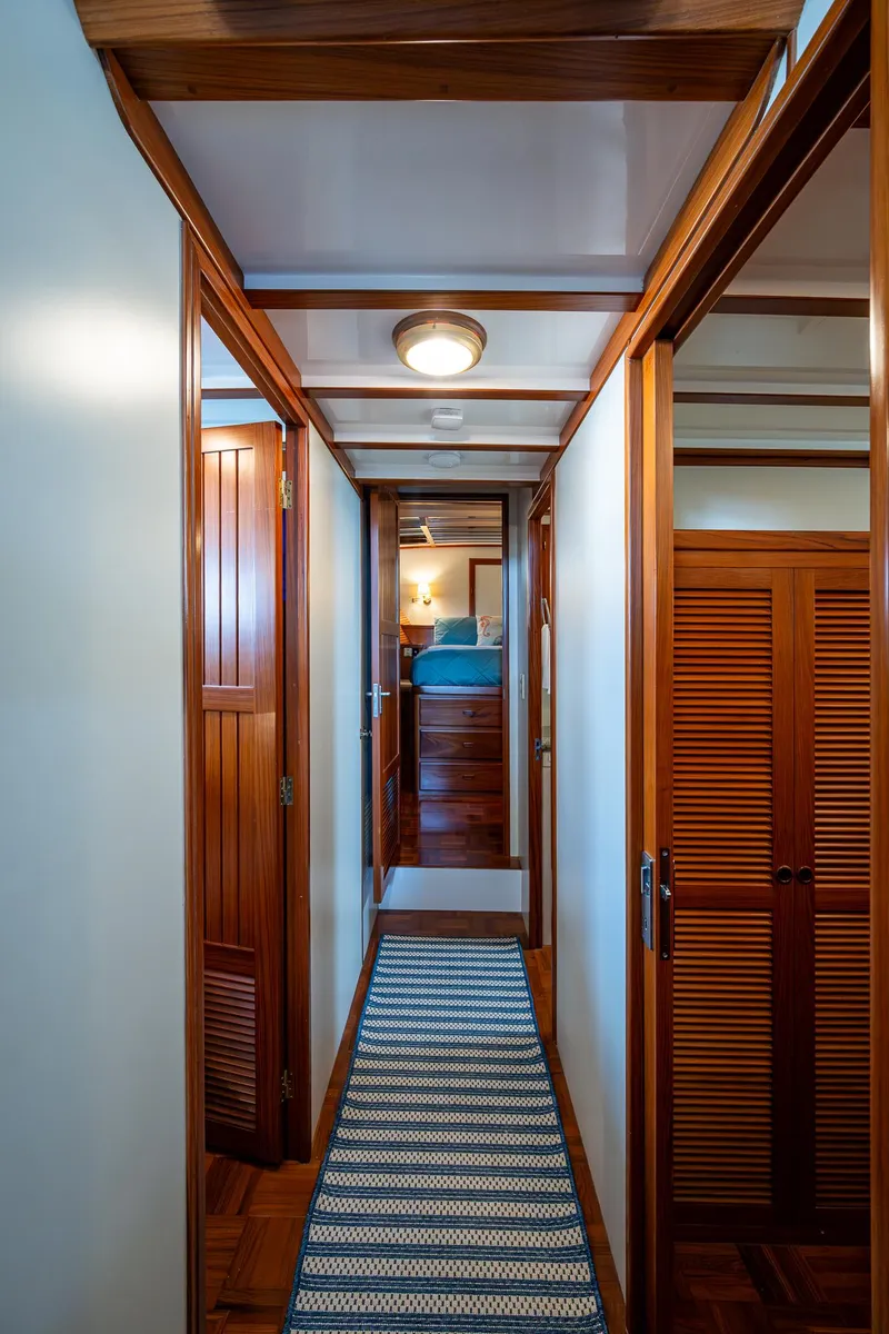 Slide: The Image of Hallway inside 2000 Kadey-Krogen 48 North Sea yacht with wooden doors and striped rug. - 41