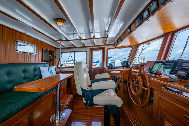Slide: The Image of Pilothouse interior of 2000 Kadey-Krogen 48 North Sea yacht with wood finish and navigation equipment. - 27