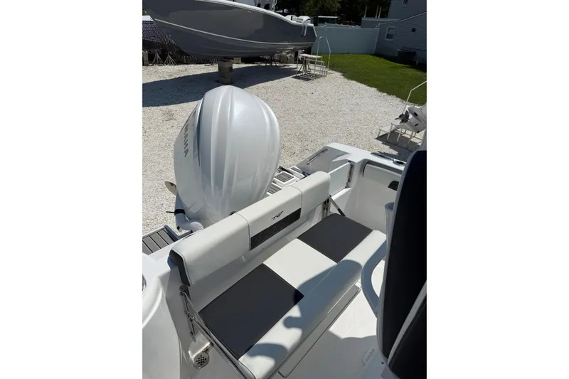 Slide: The Image of 2027 Tidewater 220 CC Adventure boat with Yamaha engine, featuring sleek seating design. - 9