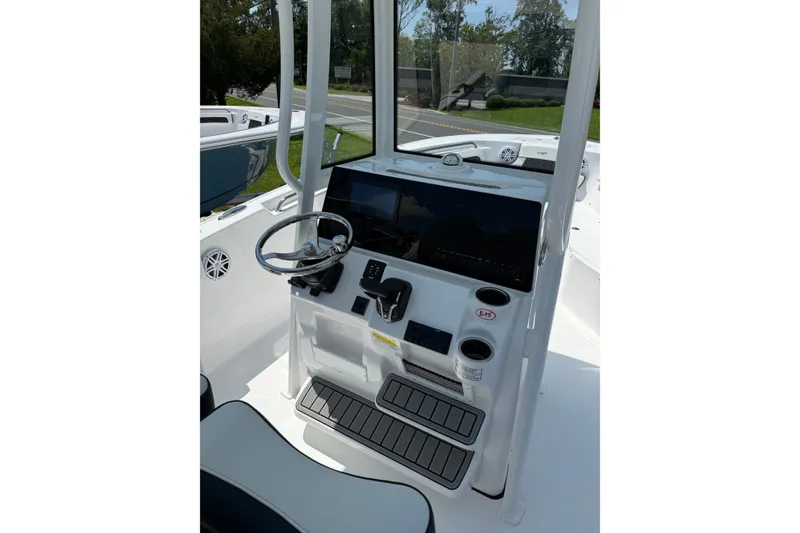 Slide: The Image of 2027 Tidewater 220 CC Adventure boat console with steering wheel and controls. - 6