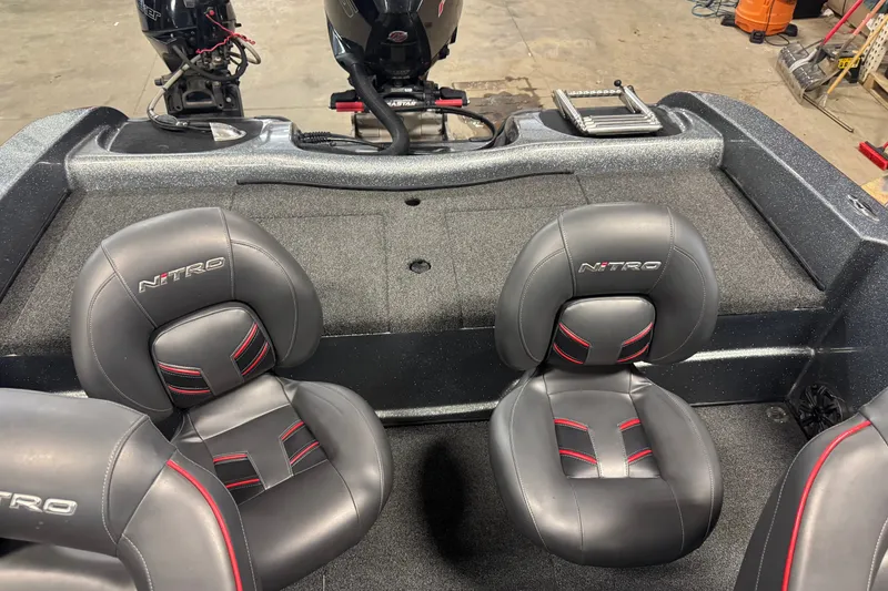 Slide: The Image of 2019 Nitro ZV19 boat interior with dual black and red seats. - 9