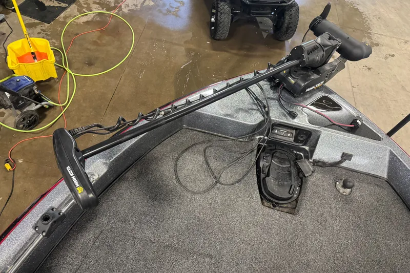 Slide: The Image of 2019 Nitro ZV19 boat with Minn Kota trolling motor on deck in a garage setting. - 14