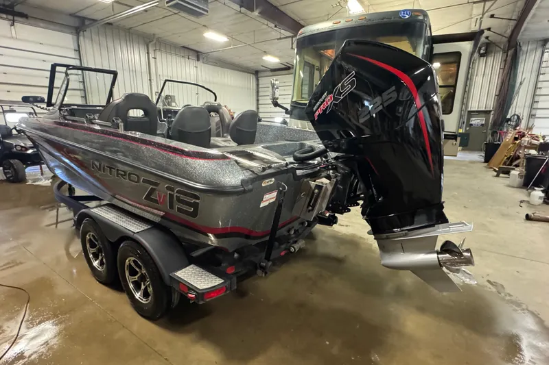 Slide: The Image of 2019 Nitro ZV19 boat with powerful engine in a garage setting. - 5