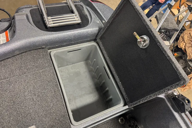 Slide: The Image of Open storage compartment in 2019 Nitro ZV19 boat with carpeted lid and ladder. - 10