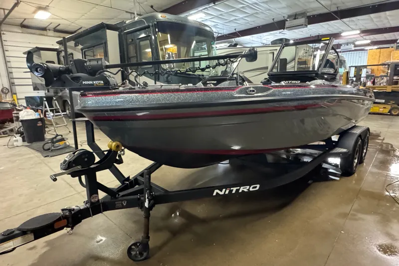 Slide: The Image of 2019 Nitro ZV19 boat on trailer in a garage setting. - 1