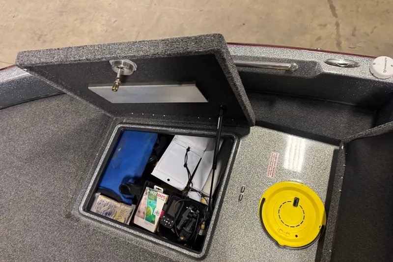 Slide: The Image of Open storage compartment in 2019 Nitro ZV19 boat, showing various items and equipment. - 18