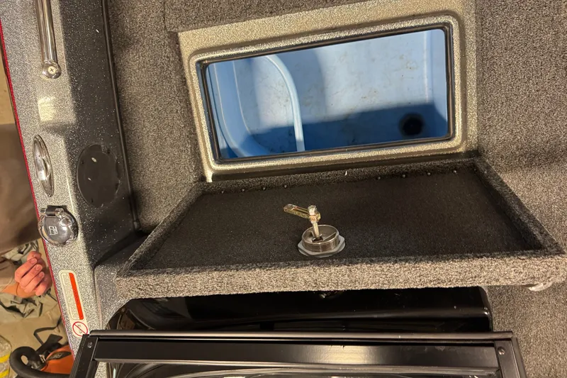 Slide: The Image of Interior view of a 2019 Nitro ZV19 boat compartment with storage and control panel. - 17