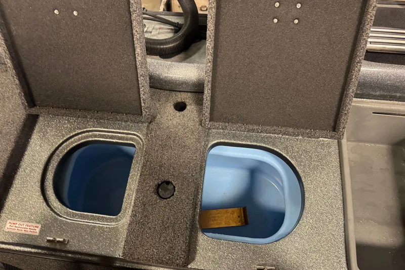 Slide: The Image of 2019 Nitro ZV19 boat storage compartments with blue interior and pump-out feature. - 11