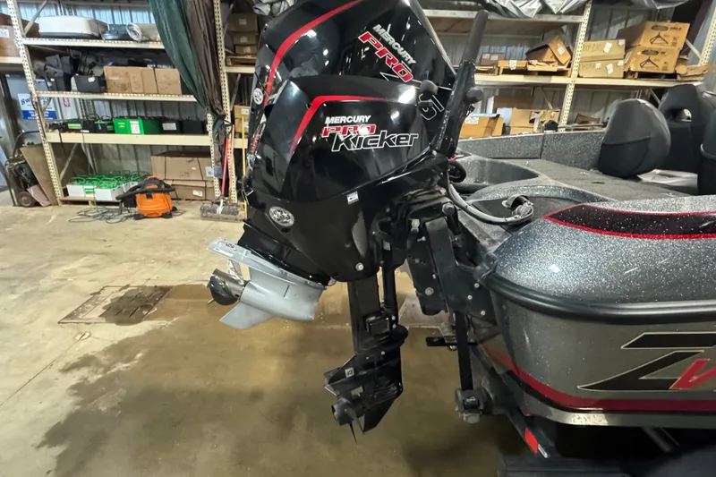 Slide: The Image of 2019 Nitro ZV19 boat with Mercury Pro Kicker motor in a workshop setting. - 4