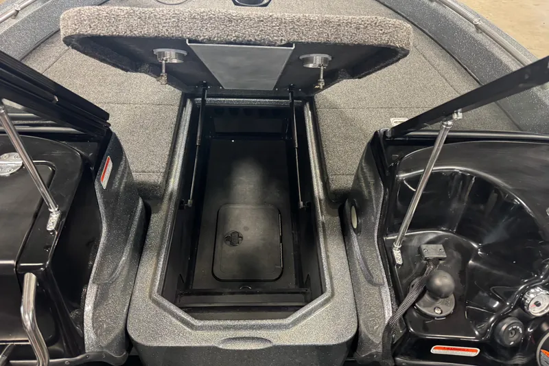 Slide: The Image of 2019 Nitro ZV19 boat storage compartment with open hatches and carpeted interior. - 13
