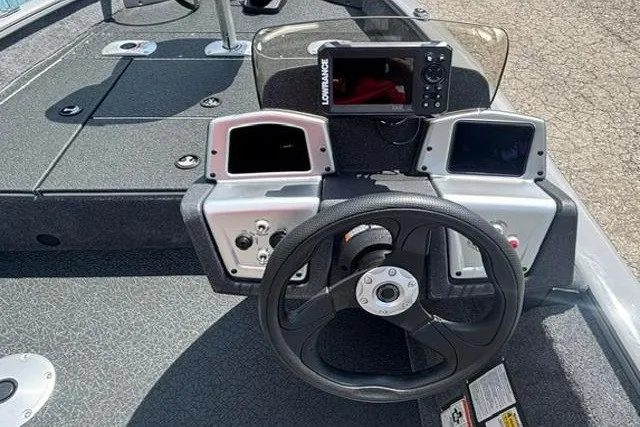 Slide: The Image of 2026 Tracker Pro Team 175 Crappie Edition boat dashboard with steering wheel and electronic display. - 15