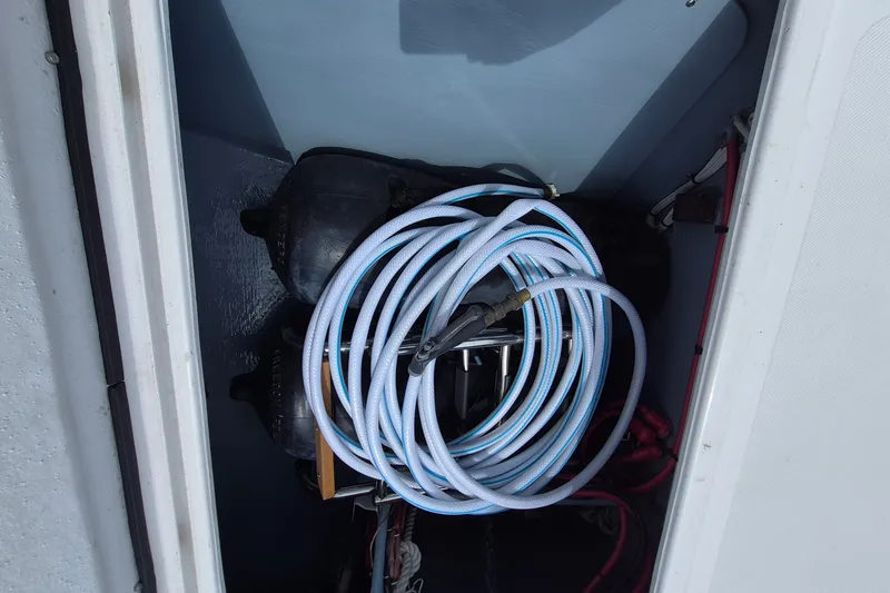 Slide: The Image of Coiled hose in storage compartment of 2005 Endeavour 44 TrawlerCat boat. - 78