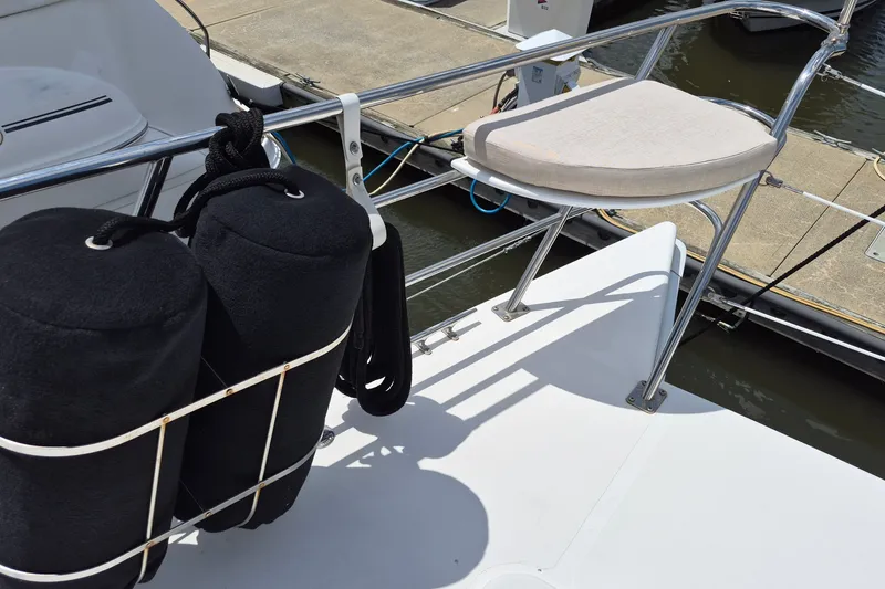 Slide: The Image of 2005 Endeavour 44 TrawlerCat boat deck with fenders and seating at marina. - 68