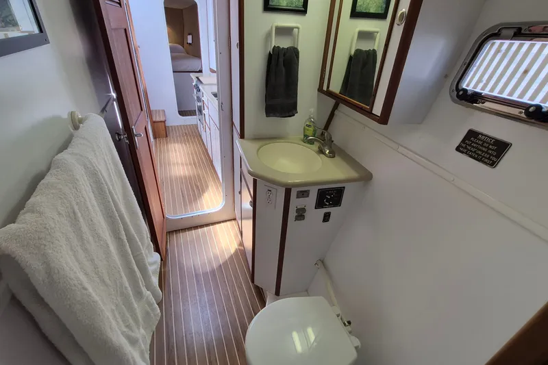 Slide: The Image of Bathroom interior of 2005 Endeavour 44 TrawlerCat with sink, mirror, and towel. - 48