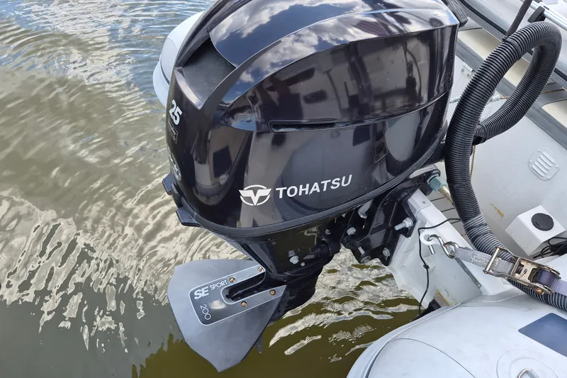 Slide: The Image of Tohatsu 25 outboard motor on Endeavour 44 TrawlerCat, 2005 model, in water. - 59