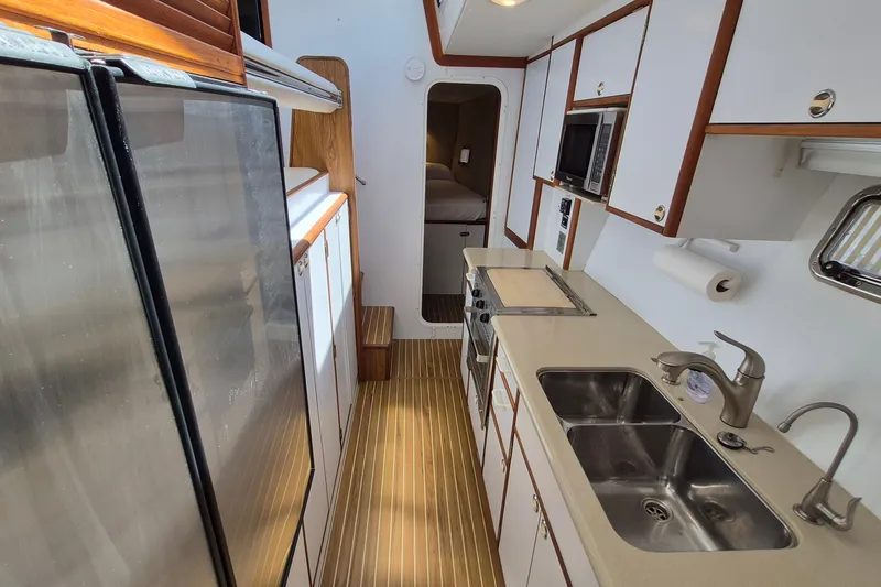 Slide: The Image of Galley kitchen in 2005 Endeavour 44 TrawlerCat with modern appliances and dual sinks. - 38