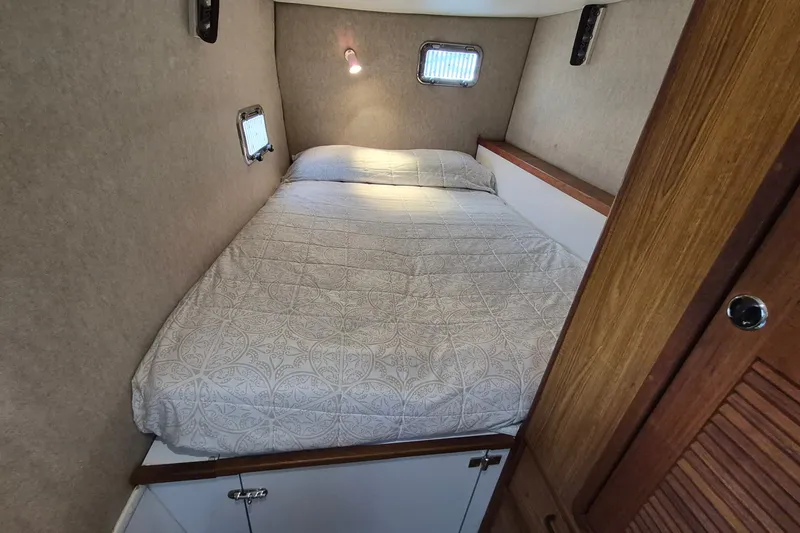 Slide: The Image of Cozy cabin bedroom in 2005 Endeavour 44 TrawlerCat with patterned bedding and wooden accents. - 50