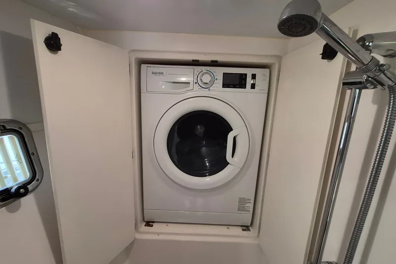 Slide: The Image of Washing machine in 2005 Endeavour 44 TrawlerCat bathroom with showerhead and porthole. - 47