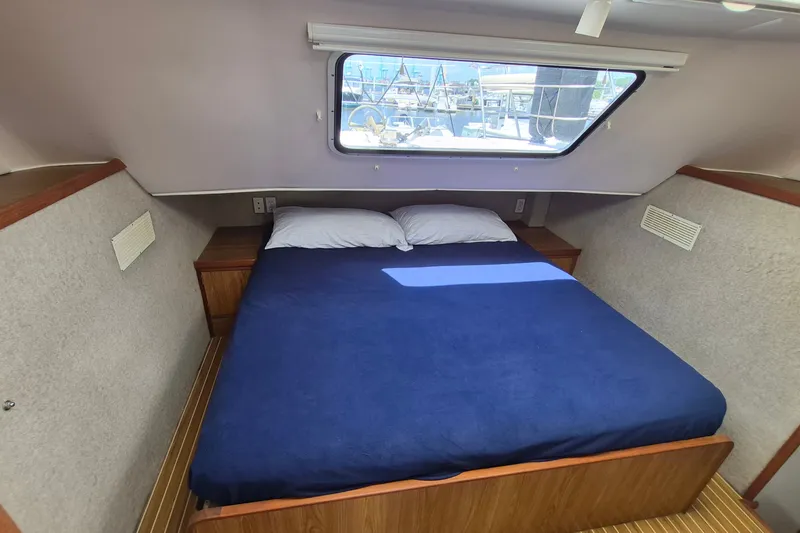 Slide: The Image of Cozy cabin interior of 2005 Endeavour 44 TrawlerCat with a double bed and window view. - 29